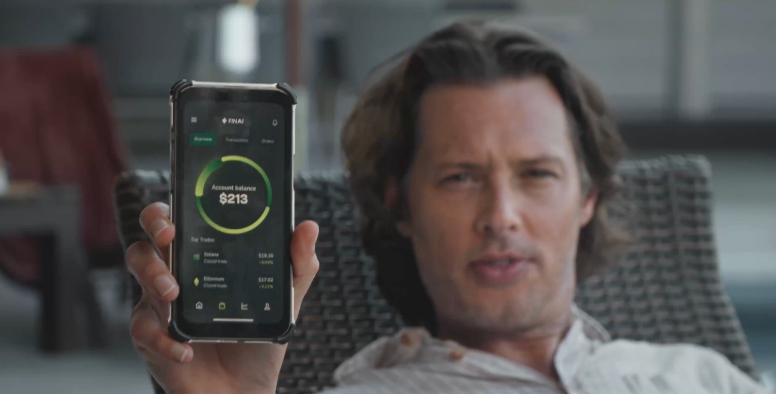 David Larsson holding a phone showing the Fin AI app